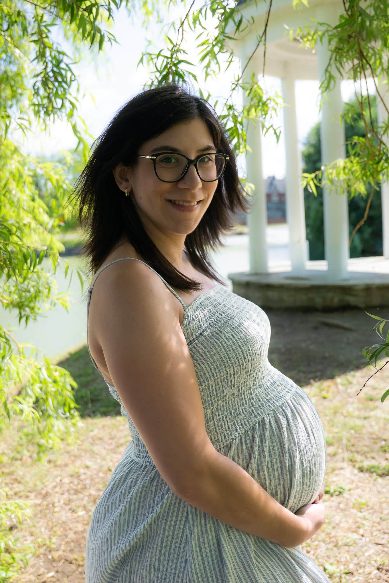 Expectant mother on a shaded porch