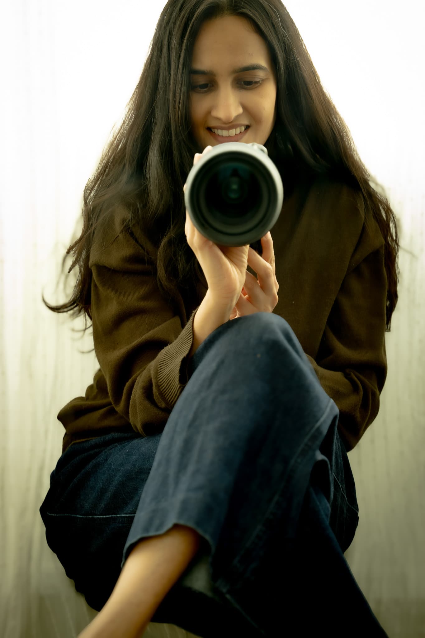 Apeksha smiling and holding her camera