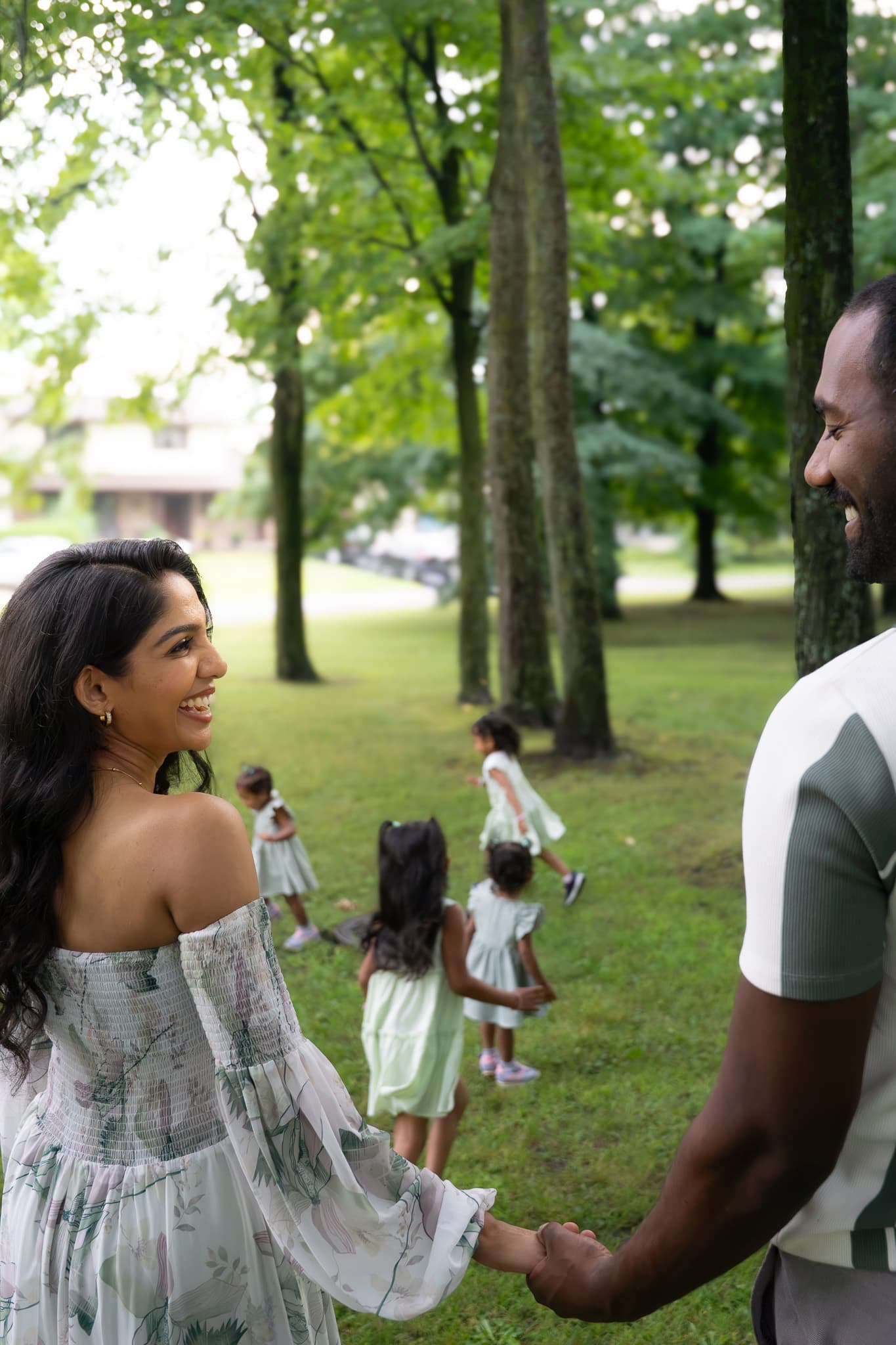 Parents walking with their daughters in a Montreal park